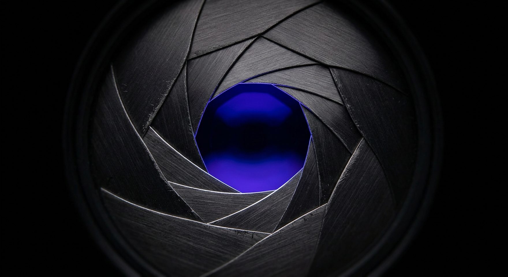 A faceted monolith on dark terrain with an indigo triangular aperture glowing at its centre.